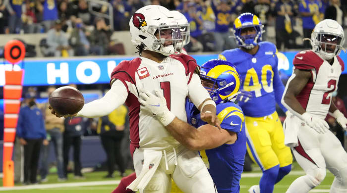 Arizona Cardinals quarterback Kyler Murray (1) throws the ball while brought down (57) during the second quarter of the NFC Wild Card playoff game.